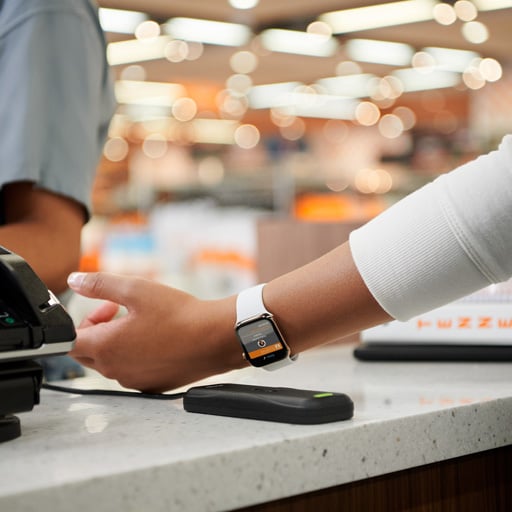 A student uses an Apple Watch to make a secure payment at a campus store, showcasing the convenience of mobile credentials for Student ID access.